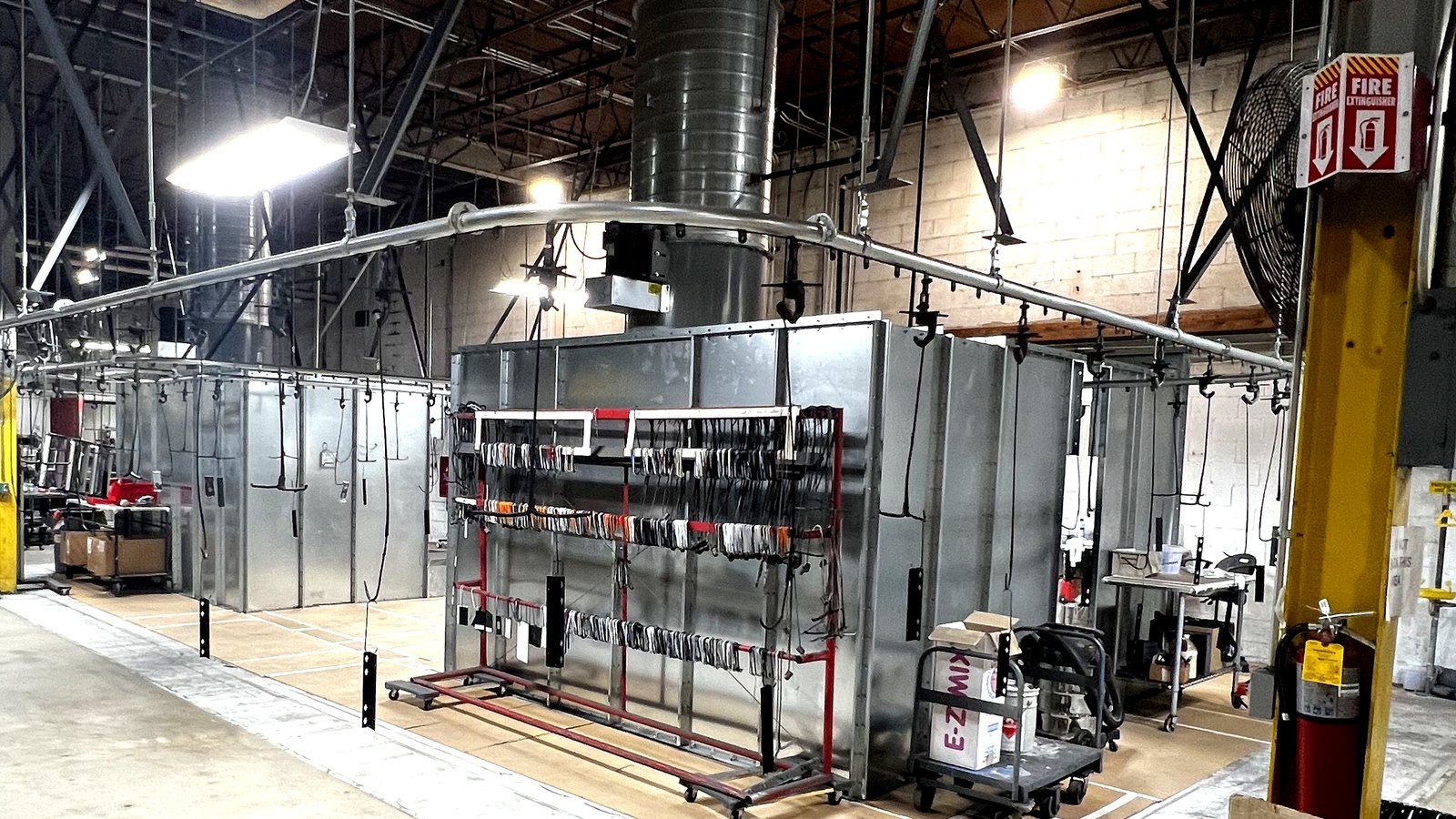 Powder coating line with overhead conveyor and racked parts at PCI
